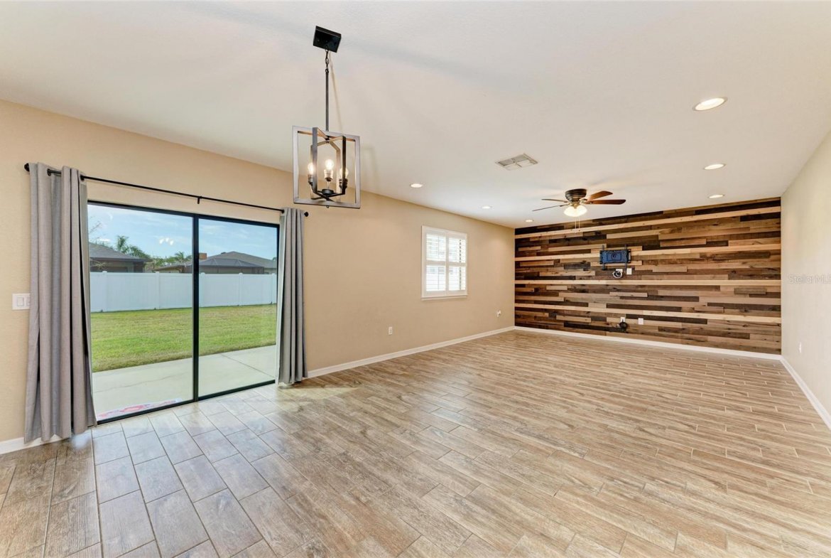 Bright living room with tile floors and large windows in Villa Milano rental home, Port Charlotte
