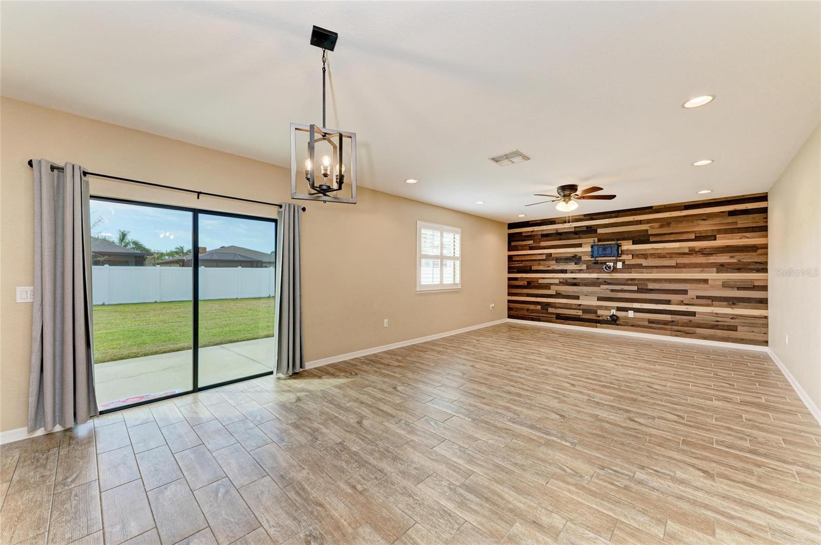 Bright living room with tile floors and large windows in Villa Milano rental home, Port Charlotte