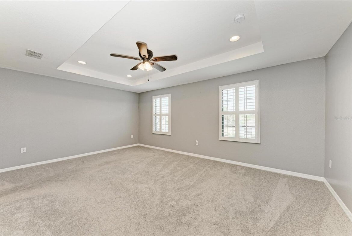 Spacious primary bedroom with carpet and walk-in closet in Villa Milano rental, Port Charlotte