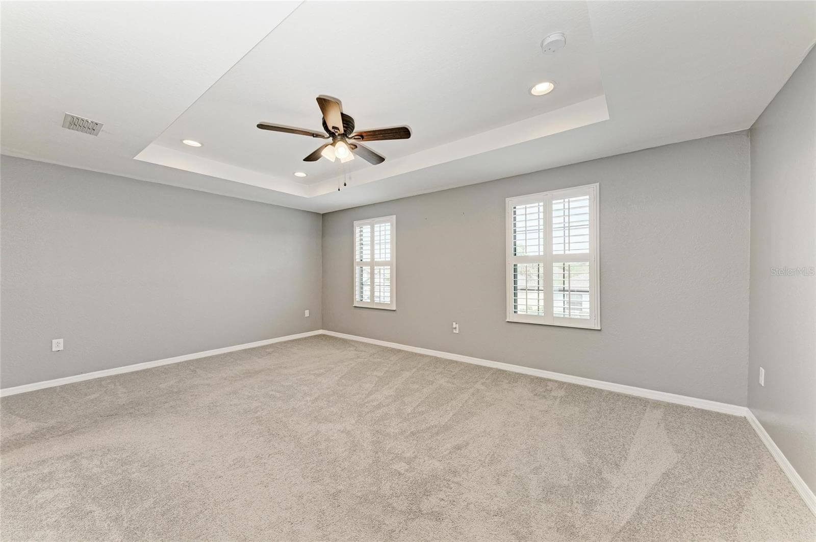 Spacious primary bedroom with carpet and walk-in closet in Villa Milano rental, Port Charlotte