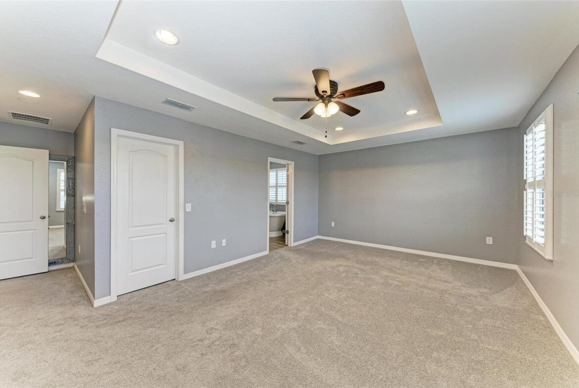 Spacious primary bedroom with carpet and walk-in closet in Villa Milano rental, Port Charlotte