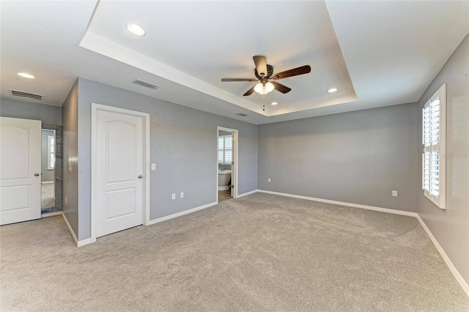 Spacious primary bedroom with carpet and walk-in closet in Villa Milano rental, Port Charlotte