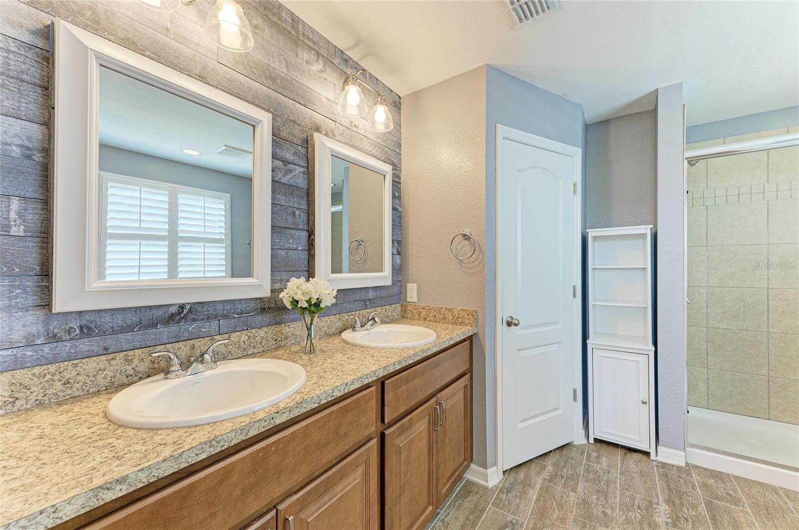 Primary bathroom with dual sinks and walk-in shower in Port Charlotte rental home
