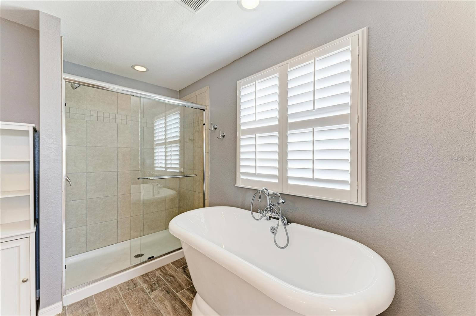 Primary bathroom with dual sinks and walk-in shower in Port Charlotte rental home