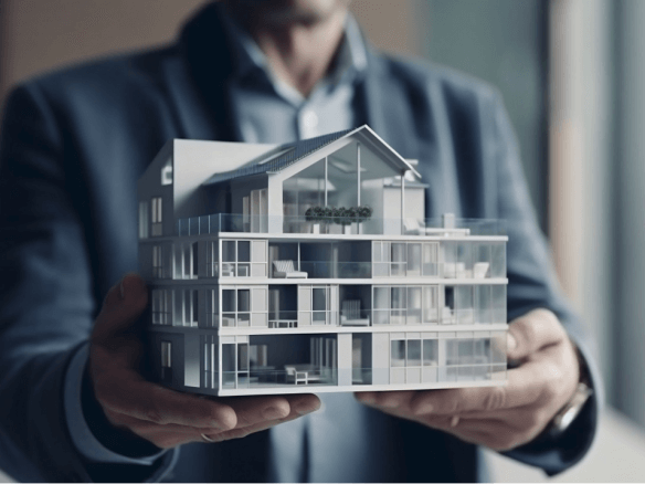 image of a man holding a model house